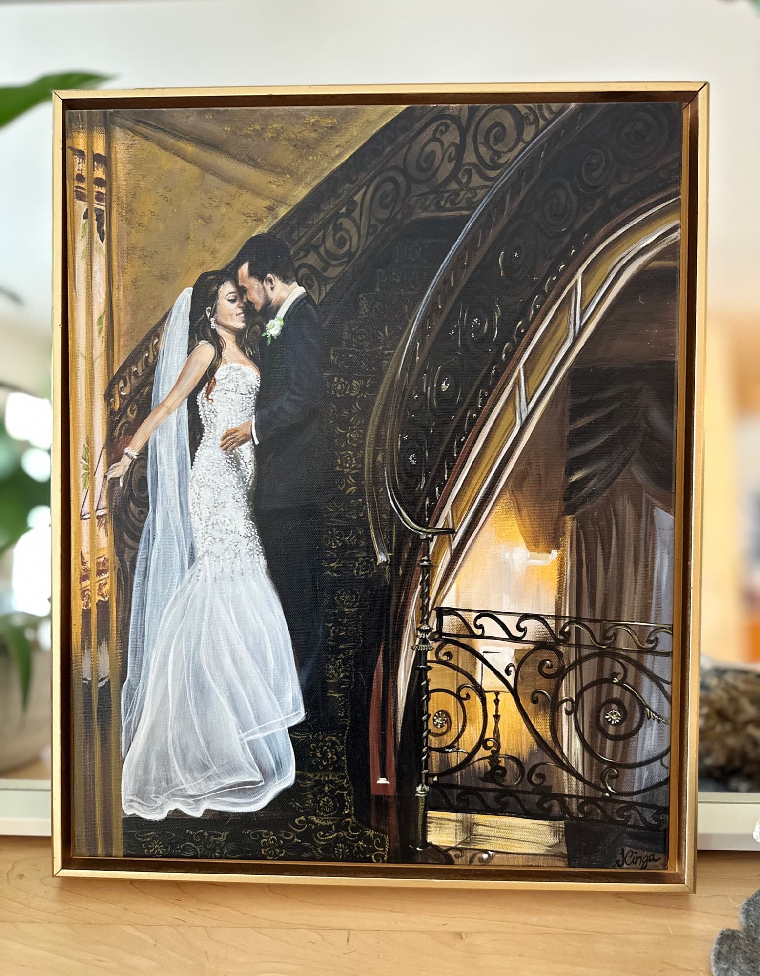 Straight-on view of the grand staircase wedding painting in its gold frame